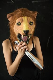 Female Killer With Lion Mask With Knife Stock Image