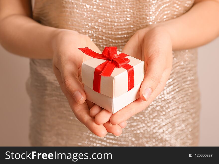 Woman holding beautiful gift box, closeup