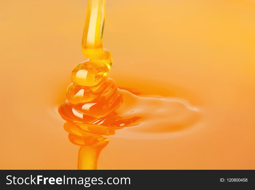 Pouring fresh sweet honey, closeup