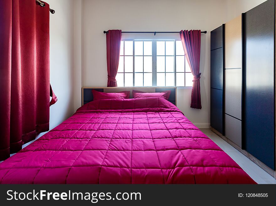 Red Pillow and Red Blanket with Red Curtain in the Bedroom with
