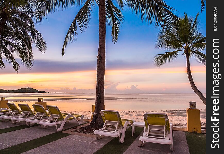 Beautiful tropical beach sea and ocean with coconut palm tree at sunrise time for travel and vacation