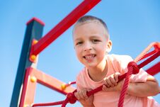 Happy Little Boy On Children Playground Climbing Frame Royalty Free Stock Photography