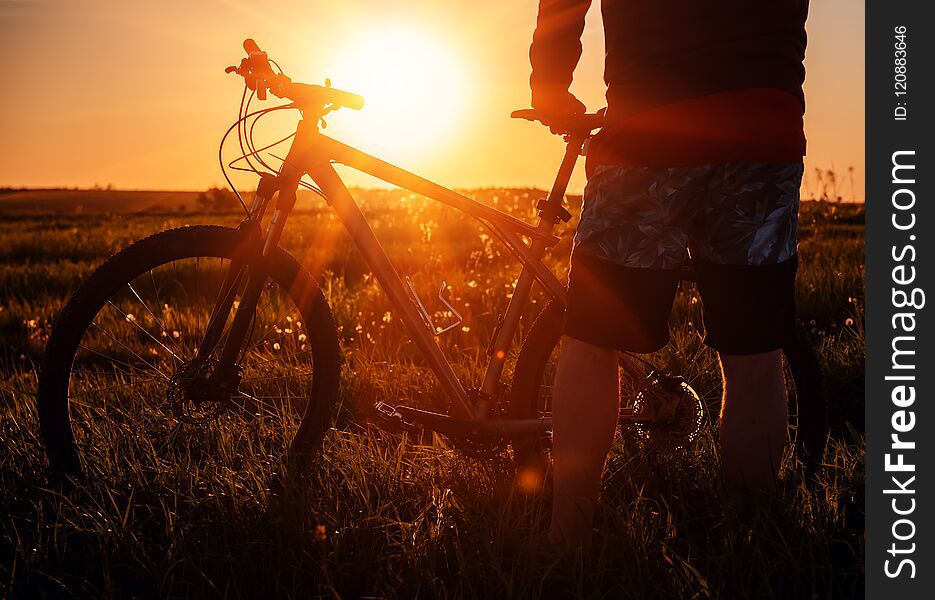 Silhouette of man with bicycle on beautiful sunset sunrise. Silhouette of man with bicycle on beautiful sunset sunrise