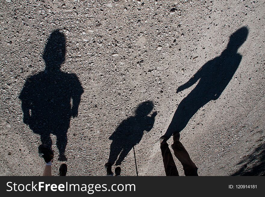 Shadows of three people walking in a mountain. Shadows of three people walking in a mountain