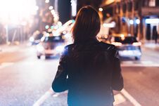 Hipster Girl In Black Leather Jacket From Back On Background Illumination Glow Bokeh Light In Night Atmospheric City, Hipster Cost Royalty Free Stock Image