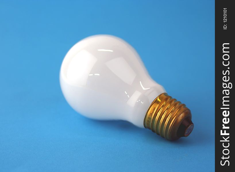 Electric Edison screw lamp on blue (focussed on screw thread)