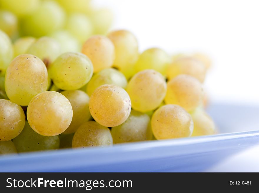 Green grape on blue dish