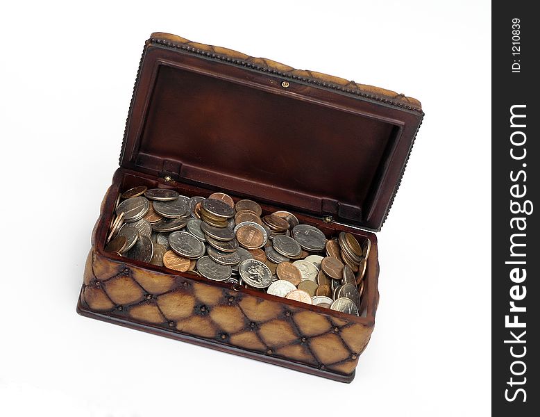 Ornate open box full of assorted coins over white. Ornate open box full of assorted coins over white