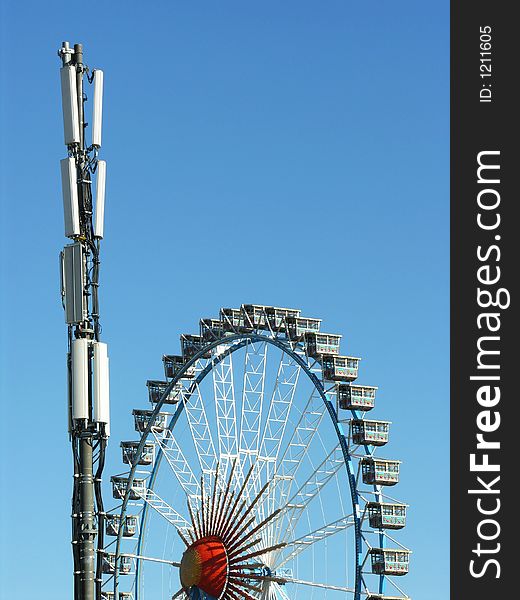 Ferris wheel and tranmitter / base station for cell phones at the Oktoberfest, Munich. Ferris wheel and tranmitter / base station for cell phones at the Oktoberfest, Munich.