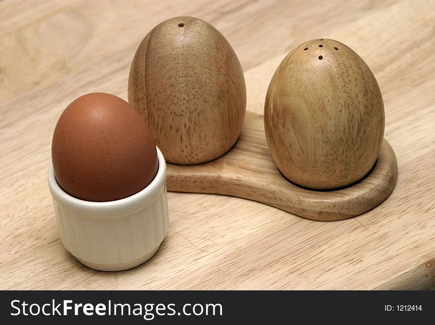 A boiled egg with condiments. A boiled egg with condiments