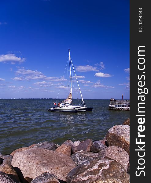 Sailboat against Blusky and small clouds.