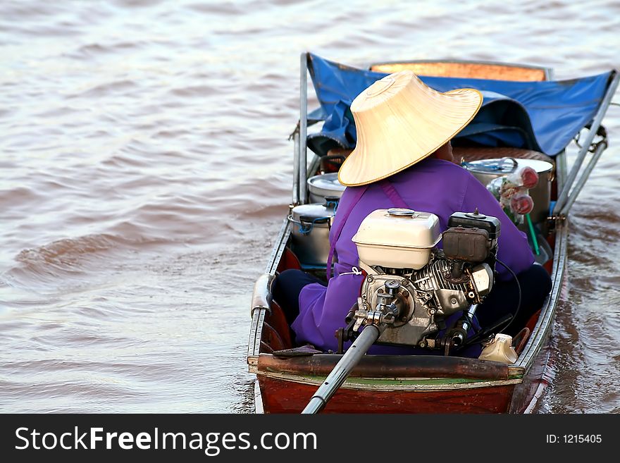 Merchant in a Long tail boat in Chaopraya river, Thailand. Merchant in a Long tail boat in Chaopraya river, Thailand