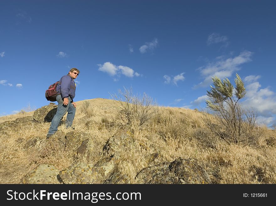 One adult with backpack climbing mountain,. One adult with backpack climbing mountain,