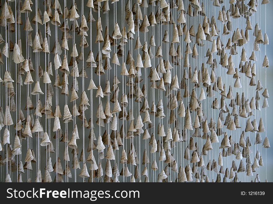 Shell chimes hanging against a wall. Shell chimes hanging against a wall