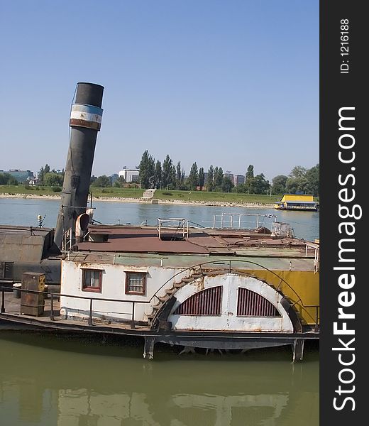 Old boat on river bank.