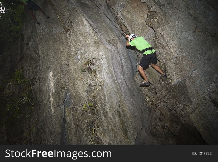 Man rock climbing in one of El Nido's limestone walls. Man rock climbing in one of El Nido's limestone walls