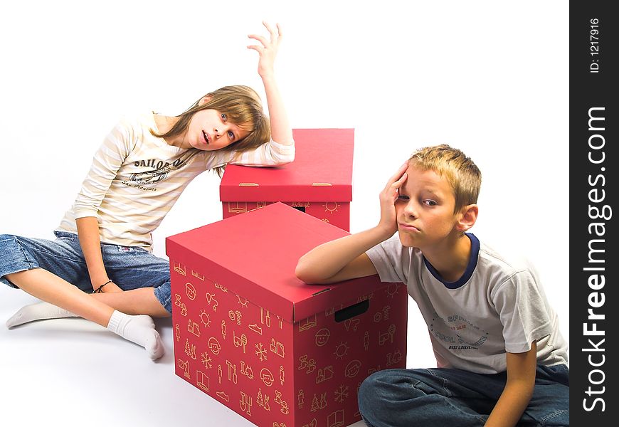 Young boy and girl on red box in white background. Young boy and girl on red box in white background
