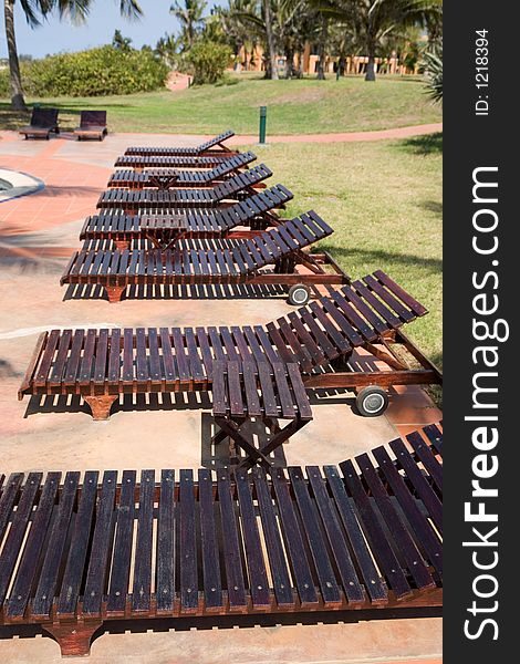 Lined up deck chairs by the pool