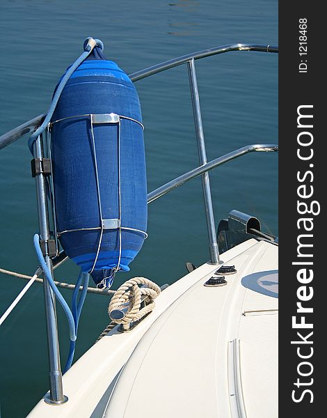 Fragment of a high-speed yacht. The white case, light-blue sea and ropes. Fragment of a high-speed yacht. The white case, light-blue sea and ropes