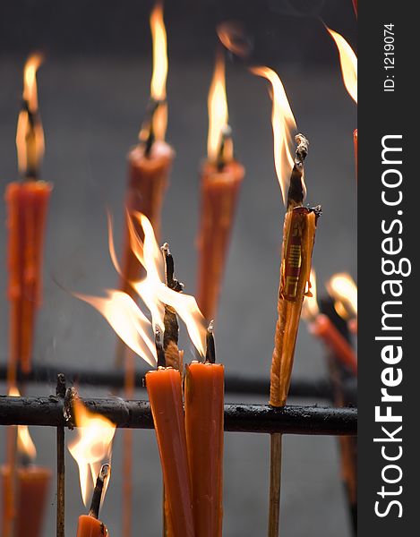 Burning candles in a Buddhist Temple