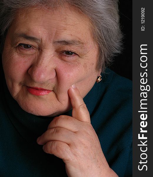 Face of aged woman who sitting on the chair and lookind