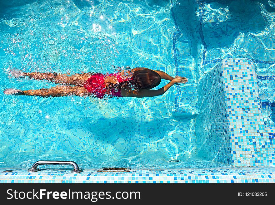 Little girl swimming in the outdoor pool. Little girl swimming in the outdoor pool