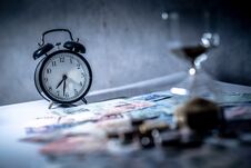 Clock And Currency On Table, Time Investment Concept Royalty Free Stock Photography