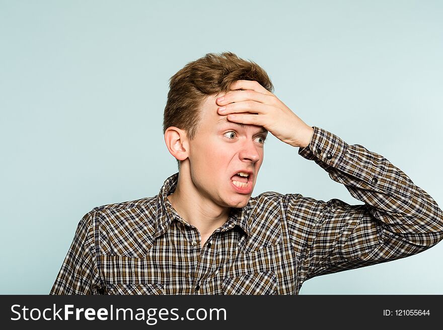 Man boiling with anger. infuriated and enraged reaction. portrait of a young guy on light background. emotion facial expression. feelings and people reaction. Man boiling with anger. infuriated and enraged reaction. portrait of a young guy on light background. emotion facial expression. feelings and people reaction.