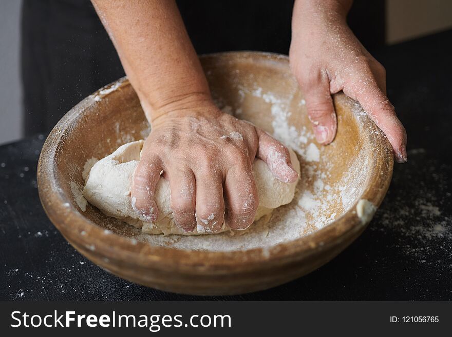 Baker hands kneading dough