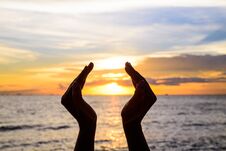 Woman Hands Holding The Sun During Sunrise Or Sunset. Stock Image