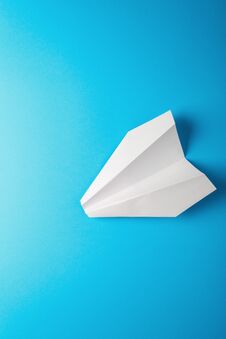 Paper Airplane On Blue Background Stock Photo