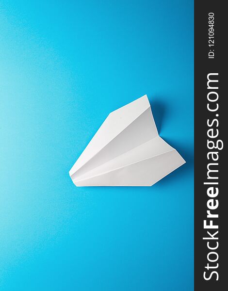 Paper airplane on blue background. travel concept