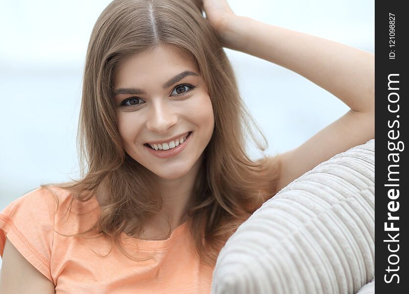 Cute smiling young woman on the background of the living room. Cute smiling young woman on the background of the living room