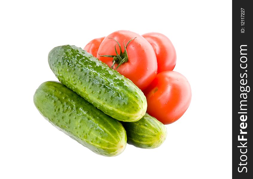 Fresh wet tomatoes and cucumbesr isolated on white. Fresh wet tomatoes and cucumbesr isolated on white