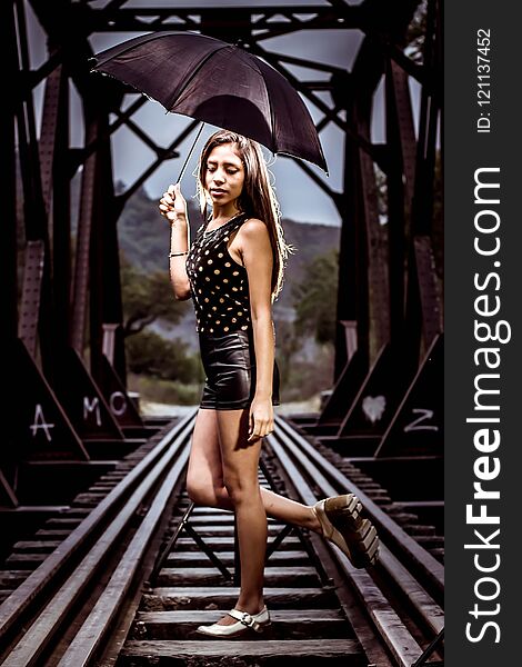 Woman posing in railroad tracks, with some women`s shoes in front focused. Woman posing in railroad tracks, with some women`s shoes in front focused