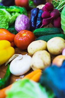 Top View Fresh Vegetables On The Wooden Counter Of A Small Vegetable Market. Stock Photo