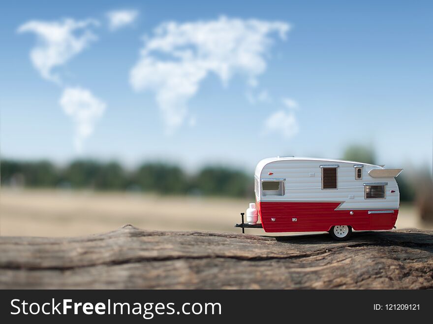 Camper van with views of the countryside and clouds in the shape of a map of the world. Camper van with views of the countryside and clouds in the shape of a map of the world