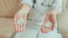 A Female Doctor In Her Hands Holds Many White Pills Royalty Free Stock Photo
