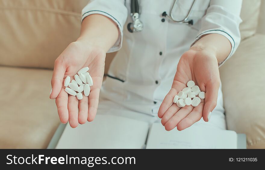 A Female Doctor In Her Hands Holds Many White Pills