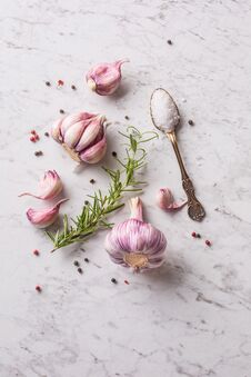 Garlic Cloves And Bulbs On White Marble Board. Stock Image