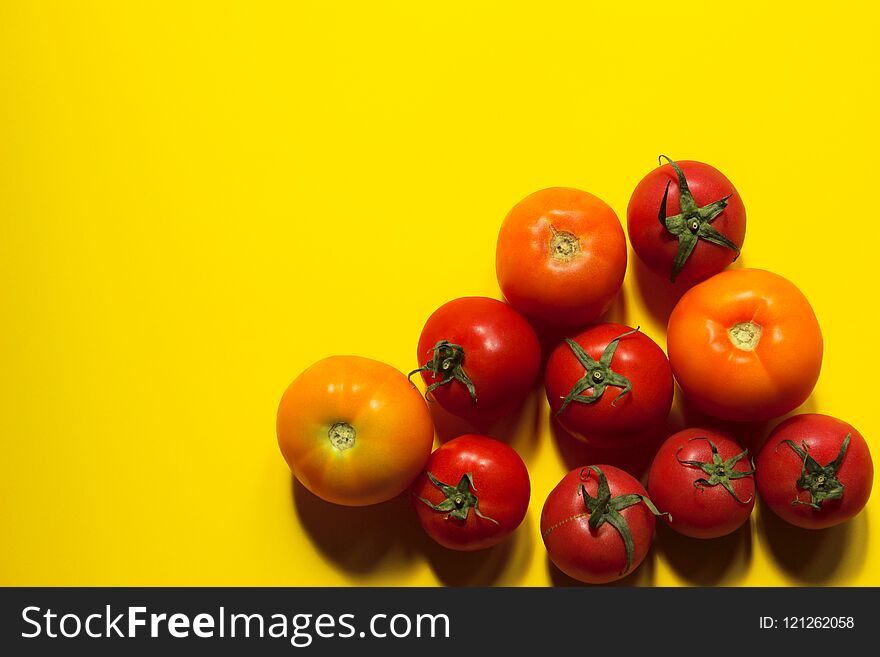 Food Concept. Tomatoes Over Yellow Background With A Lot Of Copy Space For Text. Red Tomatoes. Food Concept. Tomatoes Over Yellow Background With A Lot Of Copy Space For Text. Red Tomatoes.