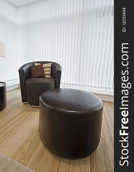 Modern luxury leather armchair and matching feet rest