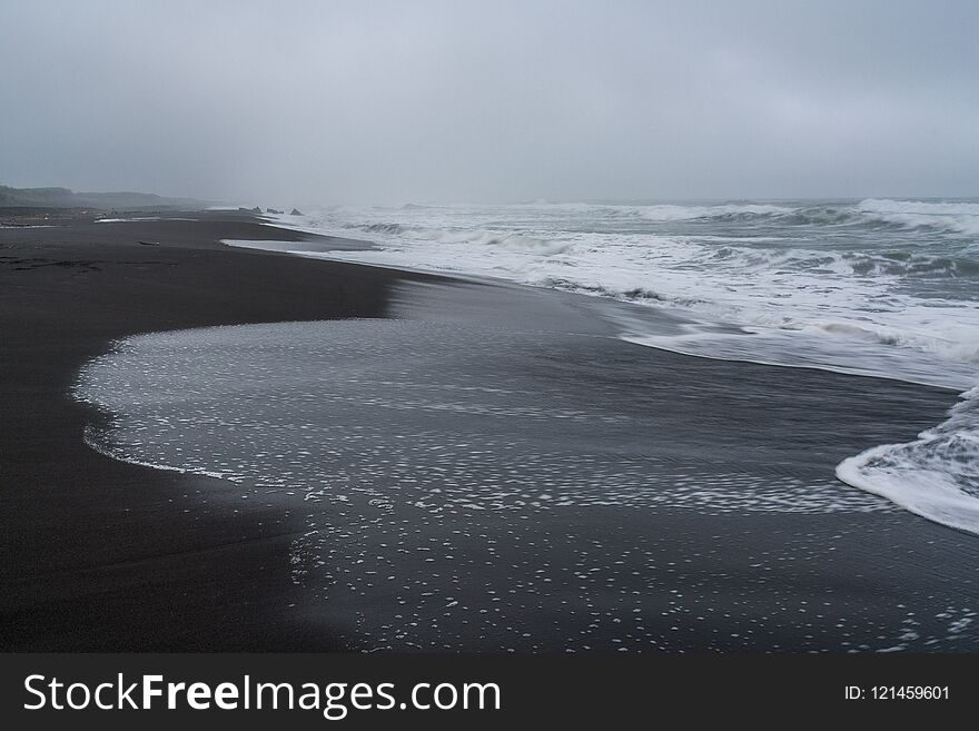 Black volcanic sand at Khalaktyrsky beach of the Pacific at Kamchatka peninsula, near Petropavlovsk-Kamchatsky, Russia