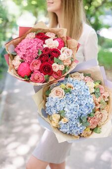 Two Beautiful Summer Bouquet. Arrangement With Mix Flowers. Young Girl Holding A Flower Arrangement With Hydrangea. The Stock Images Two Beautiful Summer Bouquet. Arrangement With Mix Flowers. Young Girl Holding A Flower Arrangement With Hydrangea. The Stock Images