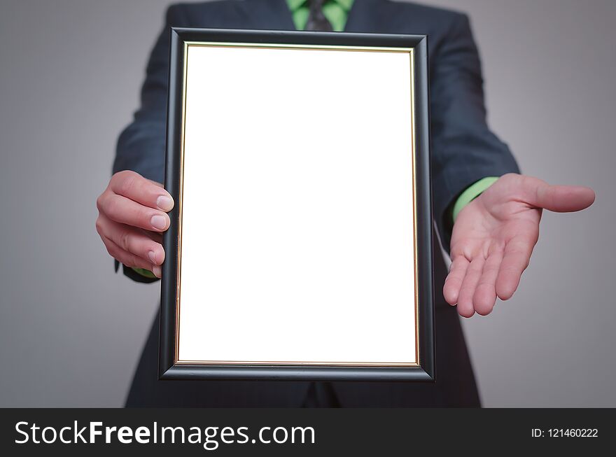 Blank diploma or certificate mock up in businessman hand. Empty photo frame border with copy space. Blank diploma or certificate mock up in businessman hand. Empty photo frame border with copy space.