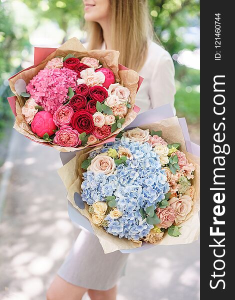 Two Beautiful summer bouquet. Arrangement with mix flowers. Young girl holding a flower arrangement with hydrangea. The