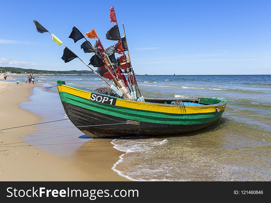 Fishing boats by the sandy beach on the Baltic Sea on a sunny day, Sopot, Poland