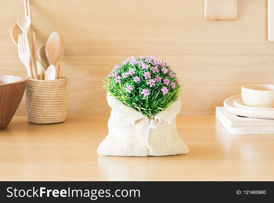 Lovely plastic flower bouquet in the wood kitchen.