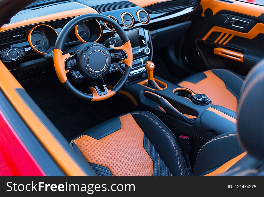 Sports car interior with orange accents.