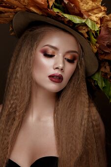 Beautiful Blond Model In Autumn Hat : Curls, Bright Makeup, Red Lips. The Beauty Face. Stock Photos